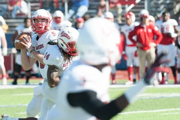 American football quarterback throwing